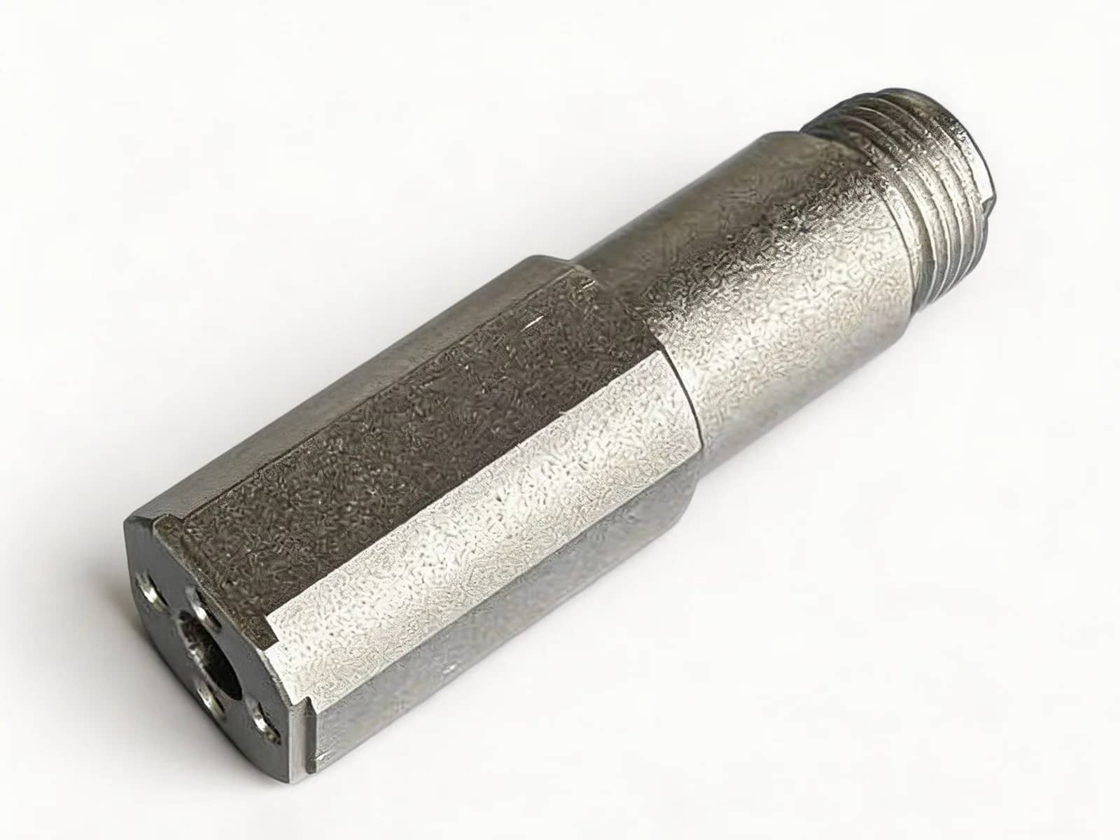 Bead-blasted matte metal hex adapter with external thread, photographed on a neutral background
