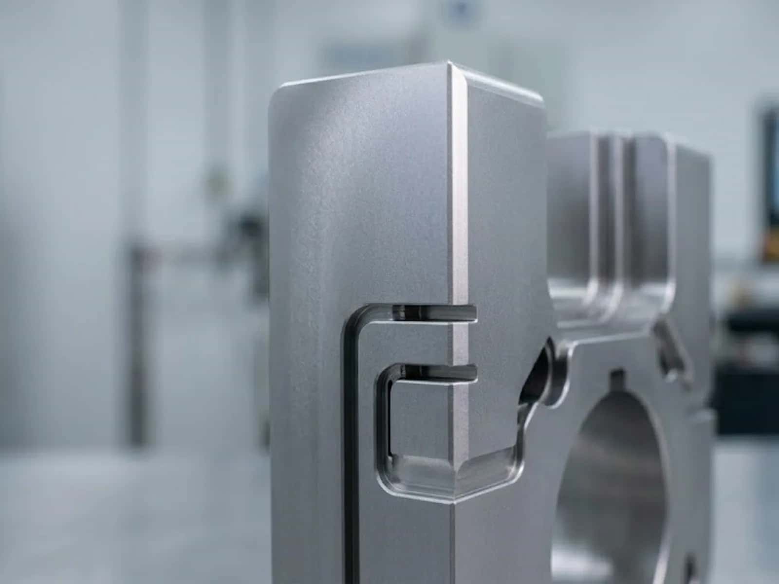 Wire EDM machined metal component with sharp slots, chamfers, and a burr-free edge